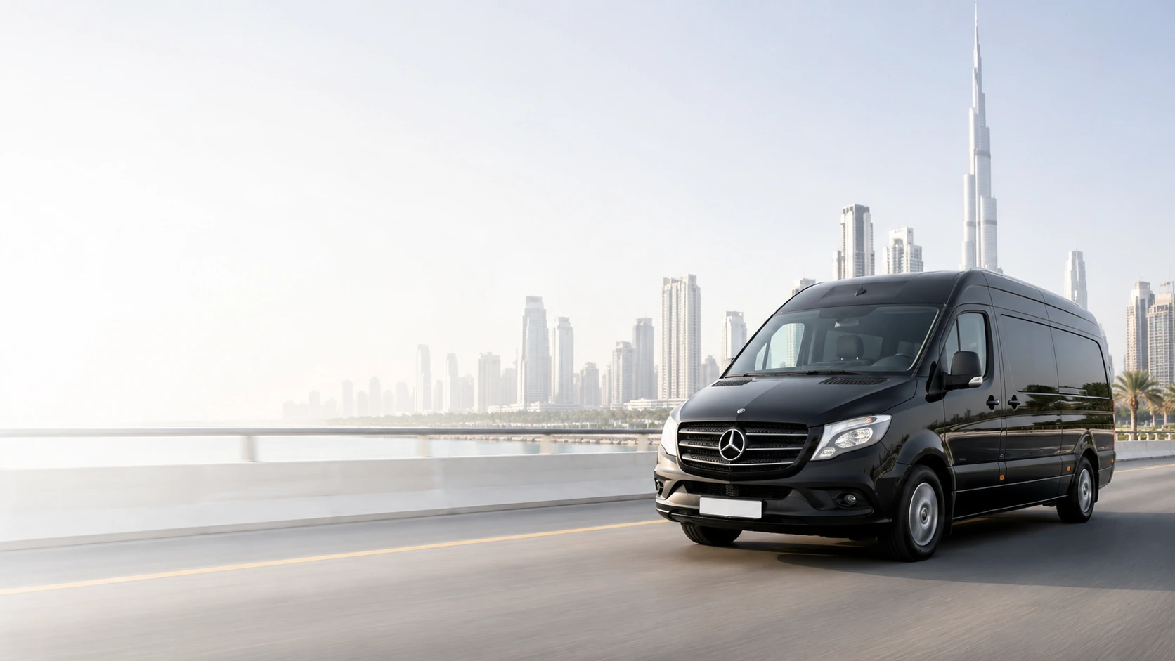 Premium black passenger van travelling through Dubai with the Burj Khalifa skyline