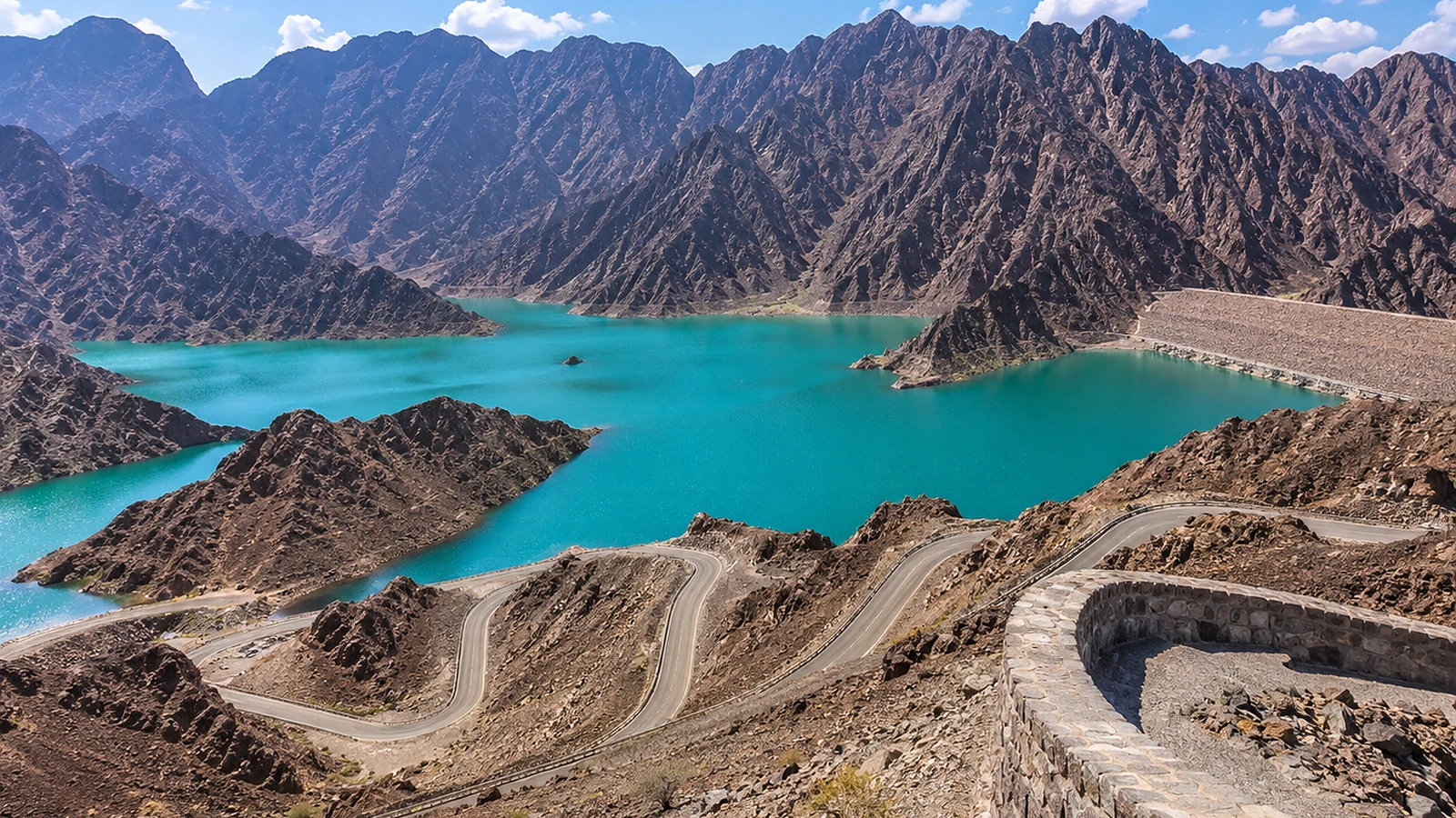 Private group vehicle on the Dubai to Hatta mountain route with Hajar Mountain scenery.